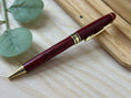 Load image into Gallery viewer, Personalized Red Wooden Ballpoint Pen with Gold Accents – Custom Engraved Pen with Optional Bamboo Gift Case Krevana Personalized Red Wooden Ballpoint Pen with Gold Accents – Custom Engraved Pen with Optional Bamboo Gift Case
