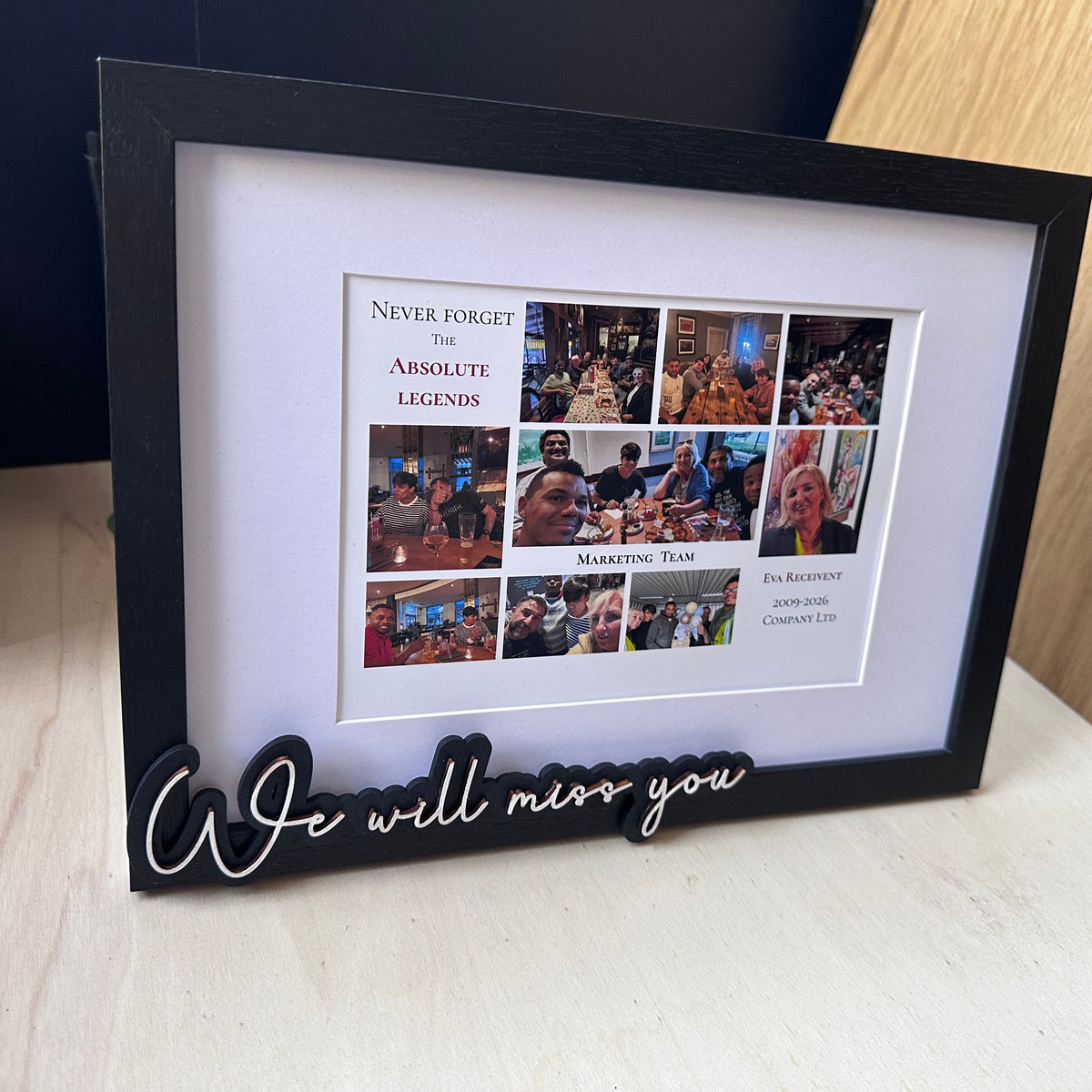 A black-framed memorial picture frame with a white mat, containing a collage of photos and the text 'Never Forget The Absolute Legends' and 'We will miss you' in script on the bottom left.