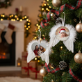 Load image into Gallery viewer, Personalised photo feather ornament hanging on the Chrismas Tree and a cozy home behind
