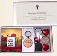 Load image into Gallery viewer, A Krevana Happy Birthday gift box set displayed open on a light beige background. The set includes a red poppy sticky notepad with the quote 'It's your own limit is your mind', a round wooden keychain reading 'You are the Best Ever', milk and dark chocolate hearts, a small tin of gourmet chocolates, 

